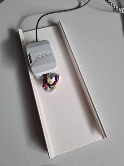 Die Rückseite eines Stück Kabelkanals. Eine graue Abzweigdose ist aufgeklebt. Eine USB-C-Einbaubuchse schaut heraus. 6 Drähte gehen von der Buchse in die Dose, zum gleichen Ende wieder hinaus, und zurück in schwarzen Schrumpfschlauch.